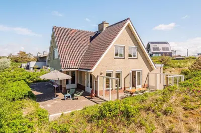 a house with a roof on top of a hill at Villa Duin en Strand in Bergen aan Zee