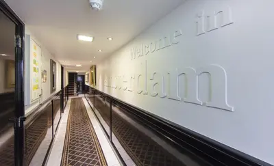 a hallway of a hospital with a sign on the wall at Dutch Masters Short Stay Apartments in Amsterdam