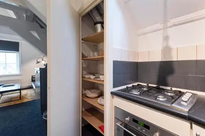 a kitchen with a stove top oven in a room at Spaarne Luxury Residence Haarlem in Haarlem