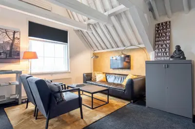 a living room with a couch and a table at Spaarne Luxury Residence Haarlem in Haarlem