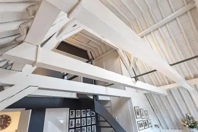 a room with white ceilings and a clock on the wall at Spaarne Luxury Residence Haarlem in Haarlem