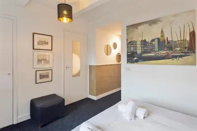 a bedroom with a bed and a painting on the wall at Spaarne Luxury Residence Haarlem in Haarlem