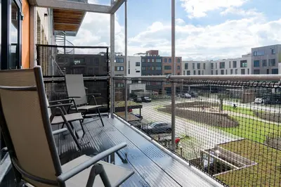 a balcony with a view of a parking lot at Huis met de krul in Amsterdam