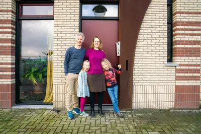 a family standing in front of a door at Huis met de krul in Amsterdam