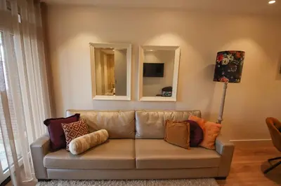 a living room with a couch and two mirrors at Volendam Lakeside Retreat - 20 min from Amsterdam in Volendam
