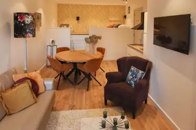 a living room with a couch and a table and chairs at Volendam Lakeside Retreat - 20 min from Amsterdam in Volendam