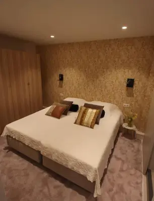 a bedroom with a large white bed with pillows at Volendam Lakeside Retreat - 20 min from Amsterdam in Volendam
