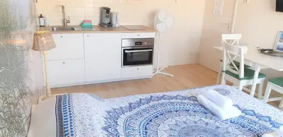 a small kitchen with a bed in a room at Pension Zandvoort aan Zee in Zandvoort
