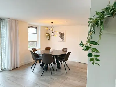a dining room with a table and chairs at Bungalow 57 op Recreatiepark De Wielen in Sint Maarten