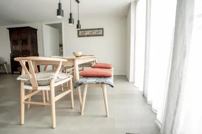 a dining room with a table and chairs at Bungalow 68 op Recreatiepark De Wielen in Sint Maarten
