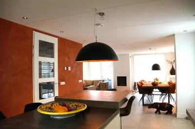a kitchen and dining room with a table with a bowl of fruit at Golden Wellness Villa Noordwijk in Noordwijk
