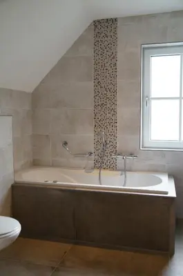 a bathroom with a bath tub and a window at Golden Wellness Villa Noordwijk in Noordwijk
