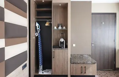 a room with a closet with a tie in it at XO Hotels Blue Tower in Amsterdam