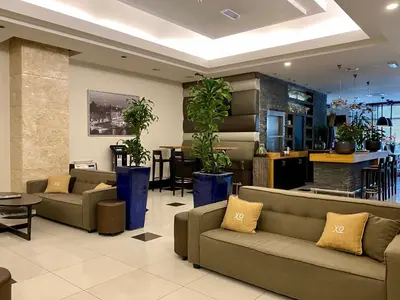 a lobby with couches and plants in a building at XO Hotels Blue Tower in Amsterdam