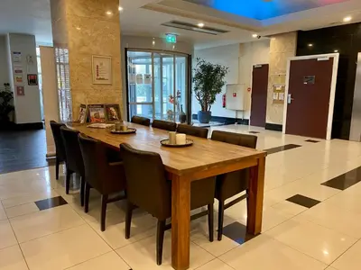 a dining room with a large wooden table and chairs at XO Hotels Blue Tower in Amsterdam