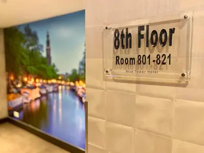 a sign on a wall with a view of a river at XO Hotels Blue Tower in Amsterdam
