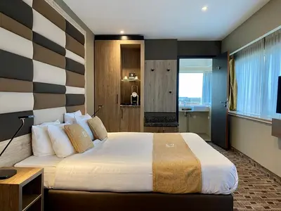 a bedroom with a large bed with a striped wall at XO Hotels Blue Tower in Amsterdam