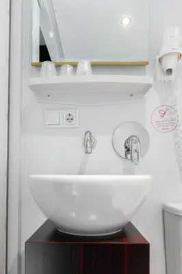 a bathroom with a white sink and a mirror at Qbic Amsterdam WTC in Amsterdam