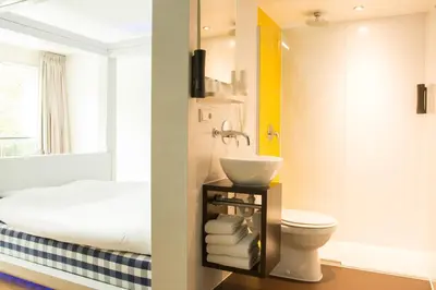 a bathroom with a sink and a toilet at Qbic Amsterdam WTC in Amsterdam