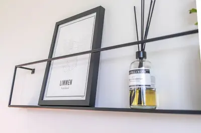a shelf with a bottle of whiskey on it at Veldt's huisje in Limmen