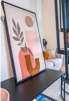 a framed picture on a table in a living room at Veldt's huisje in Limmen