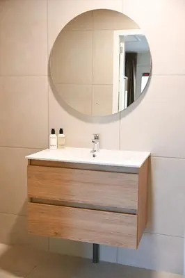 a bathroom with a sink and a mirror at High Street Apartments in Zandvoort