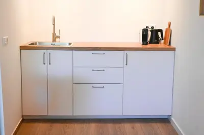 a kitchen with a sink and a counter top at High Street Apartments in Zandvoort