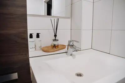 a bathroom sink with a faucet on a counter at High Street Apartments in Zandvoort