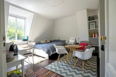 a bedroom with a bed and a table and chairs at Your own floor in authentic picturesque dikehouse - dijkhuis181 in Amsterdam