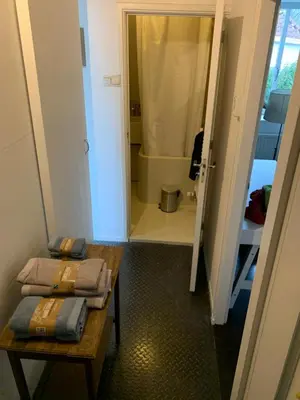 a small bathroom with a table and a shower at Your own floor in authentic picturesque dikehouse - dijkhuis181 in Amsterdam