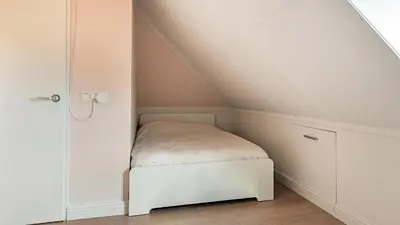 a small room with a bed in a attic at Casa Jill in Bergen