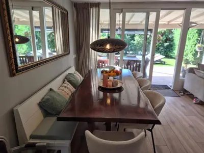 a dining room with a table with a bowl of fruit on it at Bungalow 15 op Recreatiepark De Wielen in Sint Maarten