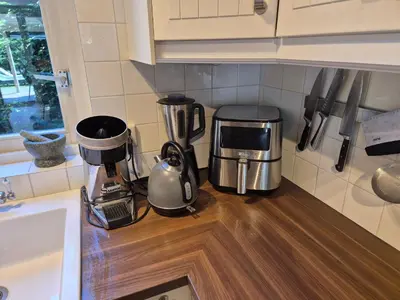 a kitchen counter with a coffee maker on a counter top at Bungalow 15 op Recreatiepark De Wielen in Sint Maarten