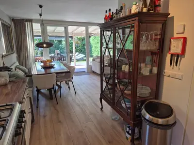 a kitchen and dining room with a dining table at Bungalow 15 op Recreatiepark De Wielen in Sint Maarten