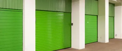 a row of green garage doors in a building at Sterflat 219 in Egmond aan Zee