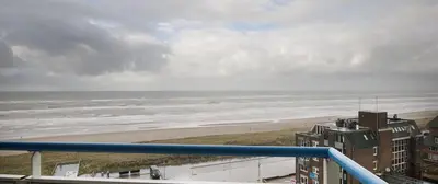 a view of the beach from a balcony at Sterflat 219 in Egmond aan Zee