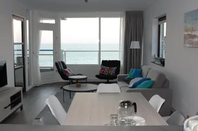 a living room with a view of the ocean at Sterflat 219 in Egmond aan Zee