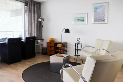 a living room with a couch and a chair at Sterflat 223 in Egmond aan Zee