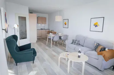 a living room with a couch and chairs and a table at Sterflat 227 in Egmond aan Zee