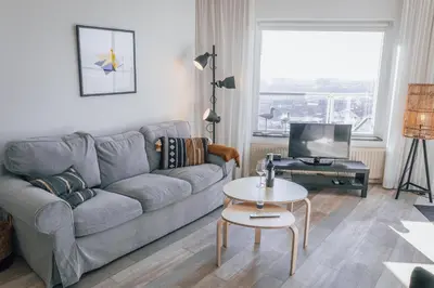 a living room with a couch and a table at Sterflat 227 in Egmond aan Zee