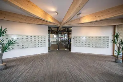 an office lobby with wooden ceilings and plants at Sterflat 249 in Egmond aan Zee