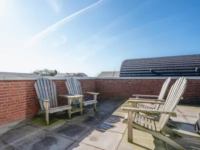 two chairs and a table on a roof at Modern Waterfront Retreat in Uitgeest