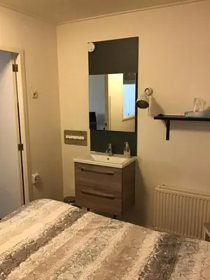 a bedroom with a sink and a mirror at Halte71 in Zandvoort