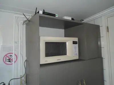 a microwave on a shelf in a kitchen at Halte71 in Zandvoort