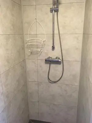 a shower with a shower head in a bathroom at Halte71 in Zandvoort