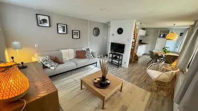 a living room with a couch and a table at Vakantiehuis Voor Anker in Egmond aan Zee