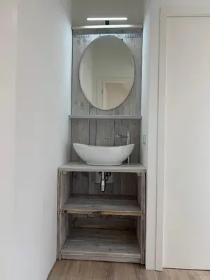 a bathroom with a sink and a mirror at Hello Noordwijk - Familiehuis Quarles van Uffordstraat 77 in Noordwijk aan Zee