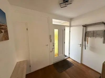 an empty room with a door and a window at Sterflat 101 in Egmond aan Zee