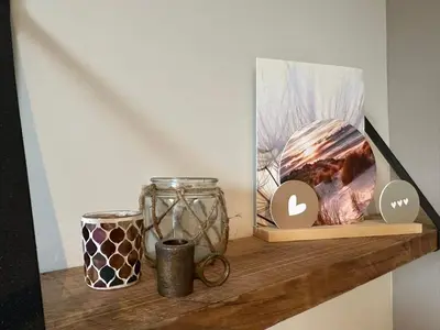 a shelf with two jars and a picture on it at Hello Noordwijk - Studio Pietheinplein 1 in Noordwijk aan Zee