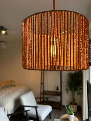 a large lamp in a living room with a bed at Hello Noordwijk - Studio Pietheinplein 1 in Noordwijk aan Zee